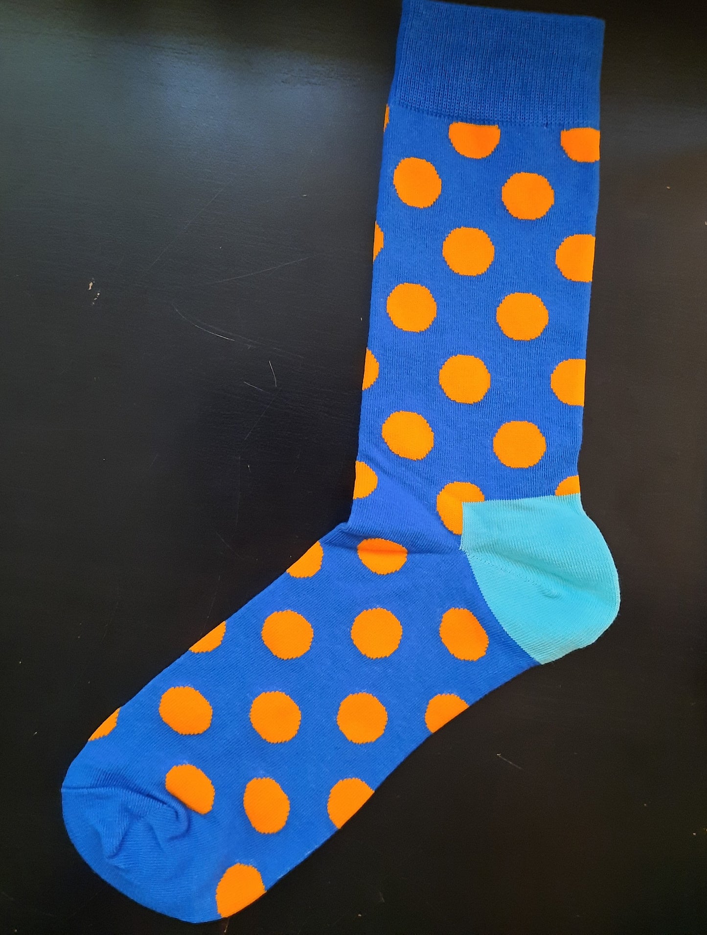 Blue socks with orange polka dots